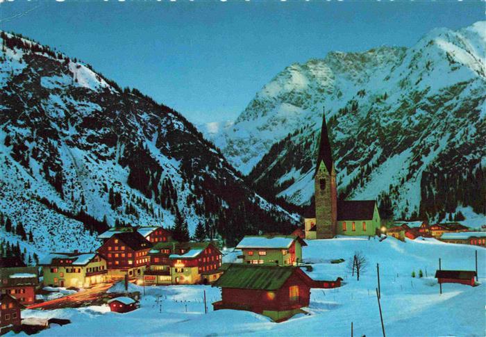 73998405 Mittelberg Kleinwalsertal AT Ortspartie bei Nacht mit Kirche